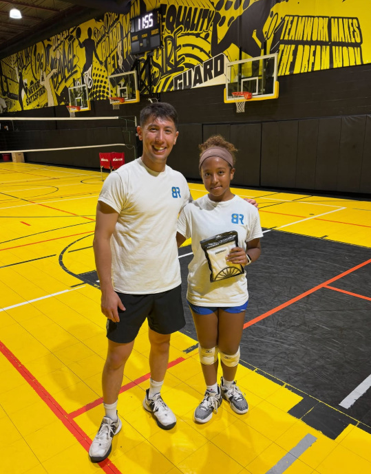 Justin Lui with a young athlete at Jungle Courts